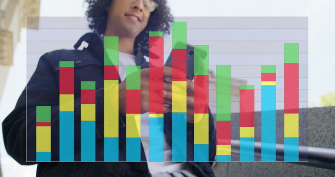 Image of colourful graph over smiling biracial man using smartphone in street