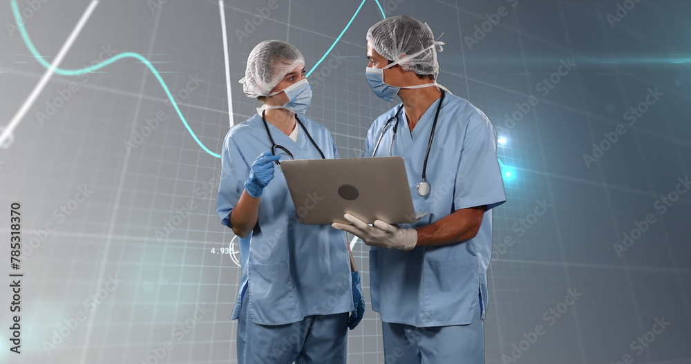 Wall mural Image of financial data and graphs over caucasian female and male surgeons