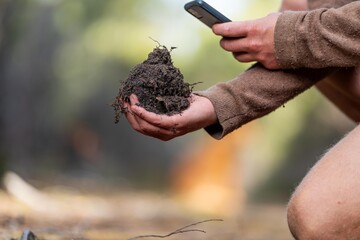 agronomist on a farm practicing agronomy holding soil, doing soil tests in her home laboratory....