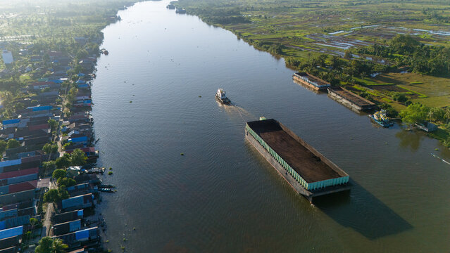 aerial view of a coal barge passing through a South Kalimantan river