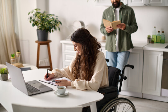 joyous woman with mobility disability working from home next to her bearded hasband reading book