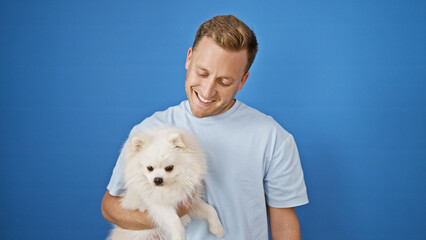 Cheerful young caucasian man laughing confidently while standing with his funny dog, radiating joy...