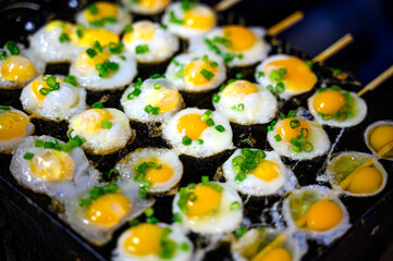 skewers fried quail egg in street food market