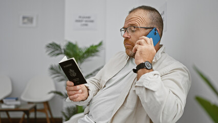 Serious-looking caucasian man, a handsome mid-aged adult in casual attire, engrossed in...