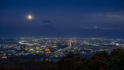 full moon over Chiang mai city at night, aerial view City night from the view point on top of mountain	
