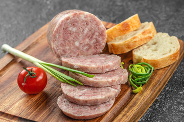 Headcheese chopped. pork meat product on a wooden board, top view. copy space