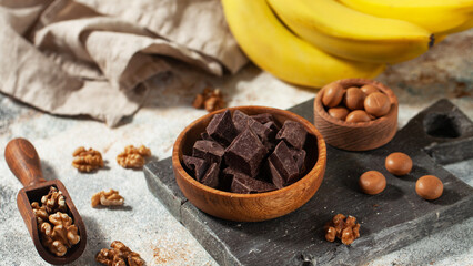 Cubes of dark artisan chocolate. Decadent dark chocolate, walnuts, and bananas