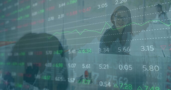 Image of stock market data processing over caucasian businesswoman using laptop at office