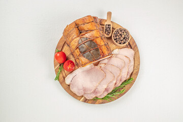 Sliced smoked ham with herbs and aromatic spices on plate