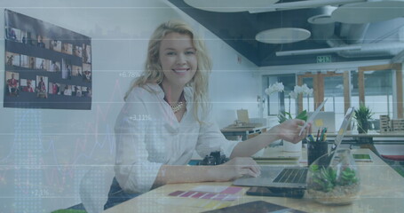 Image of financial data processing over caucasian businesswoman in office