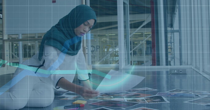 Image of financial data processing over biracial businesswoman working at office