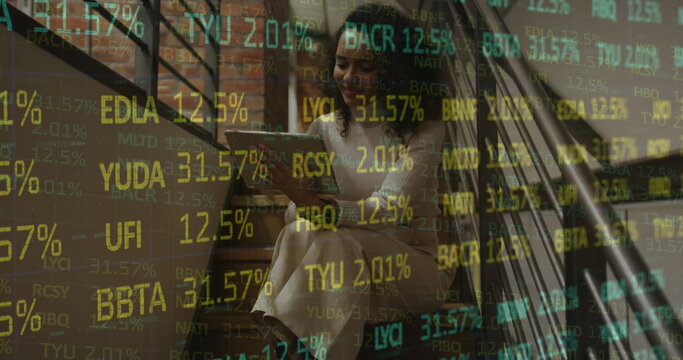 Image of stock market data processing over african american woman using digital tablet at office