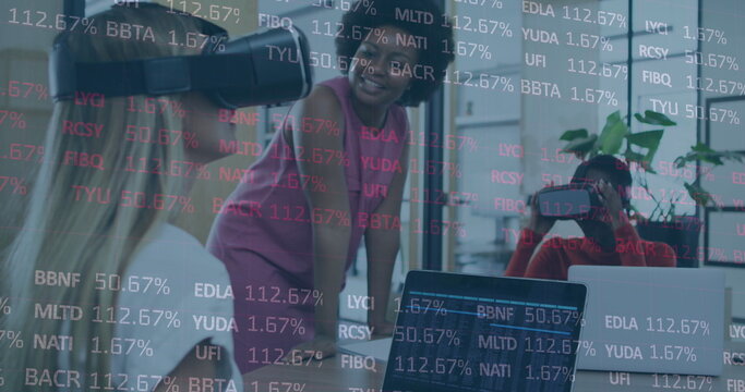 Image of stock market data processing over two diverse women wearing vr headset at office - Powered by Adobe