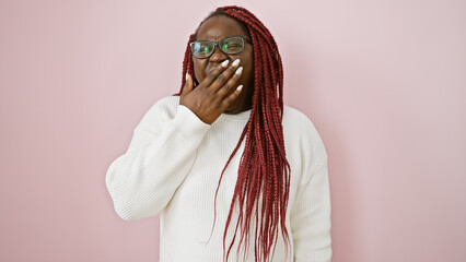 Black woman with braids yawning in white sweater over pink background, portrays casual beauty and...