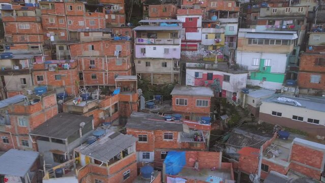 Close-up aerial tracking past colourful favela houses in Rio de Janeiro, Brazil