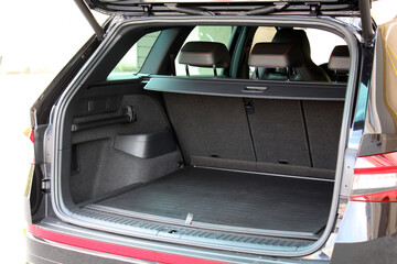 The SUV boot is open and ready for luggage loading. Empty space at the boot of the modern car. Modern car open trunk.
