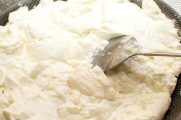 Spoon in homemade sour cream