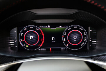 Sports car digital speedometer and tachometer. Sports car dashboard. Close-up view of the modern...
