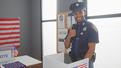 Smiling african american police officer showing thumbs up in a voting center with us flag