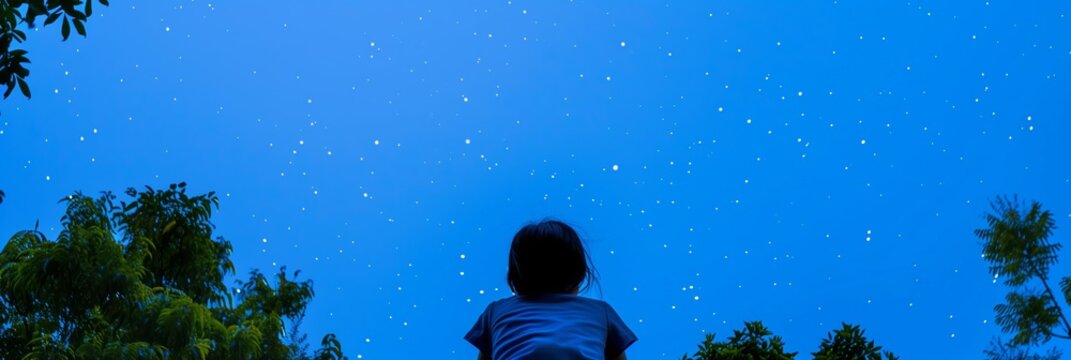 Child gazing up starry night sky wonder nature stars trees back view