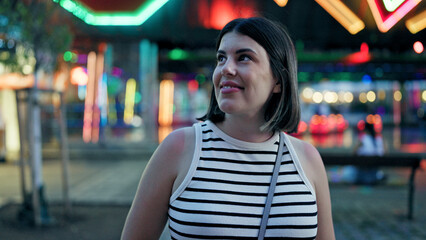 Young beautiful hispanic woman smiling looking around at Prater Vienna