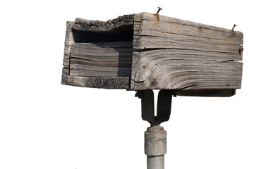 Old weathered wooden mailbox on a pole, isolated on white background