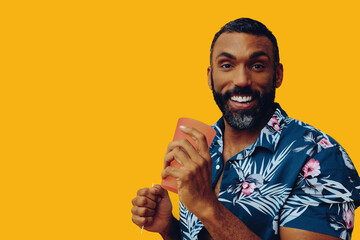 happy smiling african american man wearing Hawaiian shirt with cocktail glass