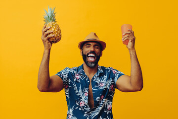 handsome african american cheerful screaming man wearing Hawaiian shirt and hat with pineapple and...