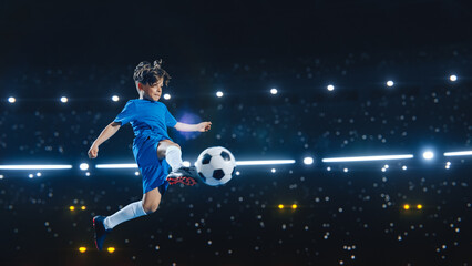 Aesthetic Shot Of Athletic Child Soccer Football Player Jumping And Kicking Ball Mid-Air On Black...