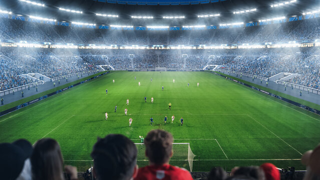 Fans Cheer for Their Favorite Team on a Stadium During International Soccer Championship Match. Teams Play, Crowds of Fans Watch Closely, Expecting a Goal. Football Cup Tournament On National Arena