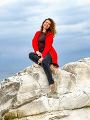 girl in a red jacket on the seashore