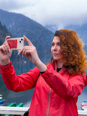 woman with smartphone taking selfie - 785357585