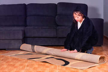 Fototapeta premium Preparing Your Home: A Young Woman Masters the Art of Taking Care of Her Space
