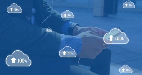 Image of digital clouds with percent going up over man using smartphone