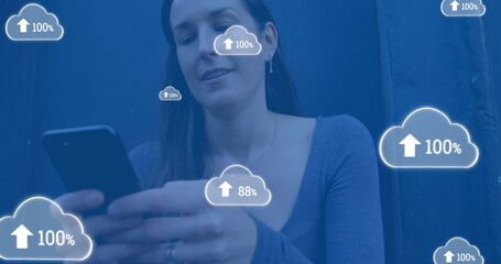 Image of digital clouds with percent going up over woman using smartphone
