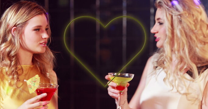 Image of heart over smiling diverse group of friends with drinks