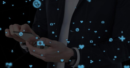 Image of network of connections with icons over men using smartphone