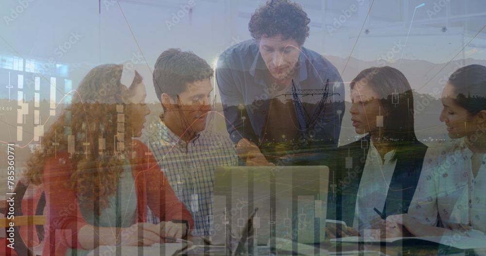 Wall mural Image of finance data over group of diverse businesspeople working with technology in office