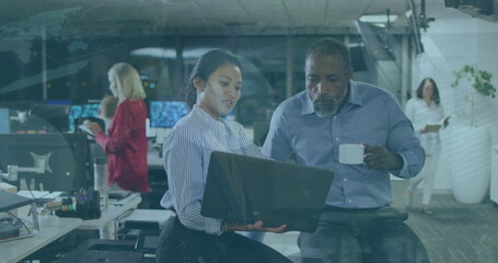 Image of data processing over diverse business people using laptop in office