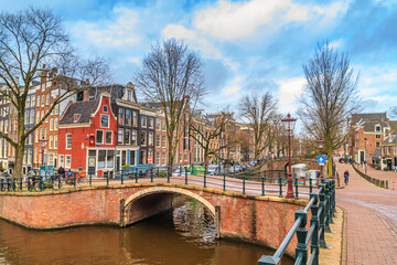 Cityscape on a sunny winter day - view of the bridges and canals in the historic center of Amsterdam, The Netherlands