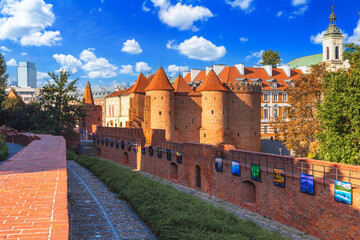 Cityscape with historic medieval fortification building Warsaw Barbican and Church of the Holy...