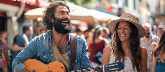 Fototapeta na wymiar Happy hippie couple playing music and singing with friends in the street, having fun during outdoor party on a sunny day.