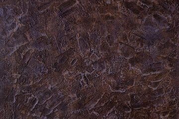 Abstract brown plastered textured grunge background in the form of a rough covered stucco wall, closeup
