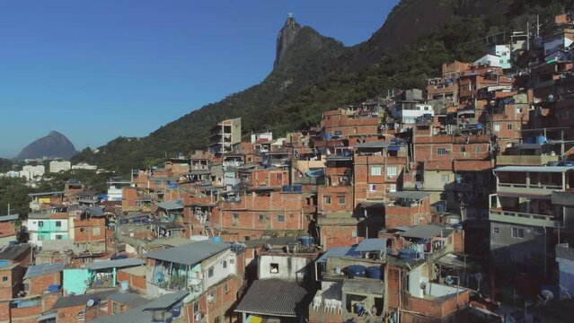 Aerial rising from hillside favela to Christ the Redeemer statue in Rio de Janeiro, Brazil