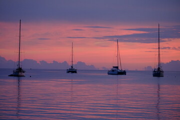 Some sailing boats at dusk, anchored on the lagoon. Rangiroa, Tuamotu archipelago, French Polynesia...