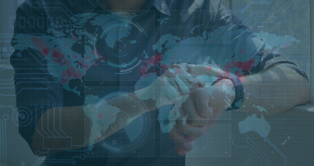 Image of data processing on screens over caucasian man checking smartwatch