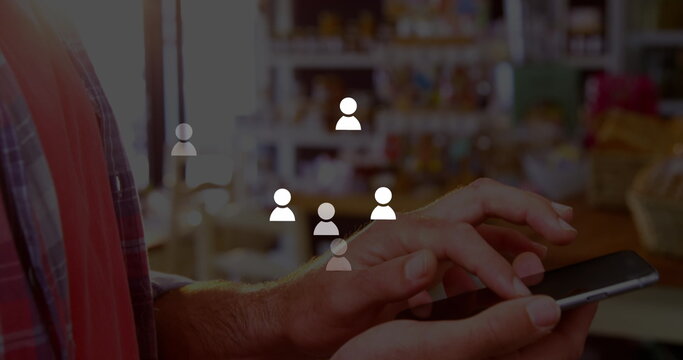 Image of icons over hands of caucasisn man using smartphone