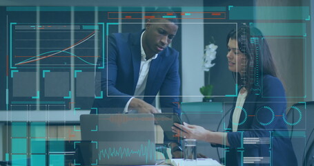 Image of digital screen with data over diverse coworkers in office