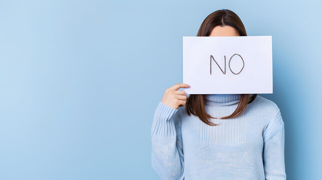 business woman cover her face with NO sign  white paper for hide emotion 
