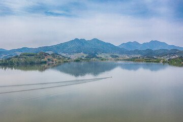 A view of the riverside with canola flowers taken by a drone